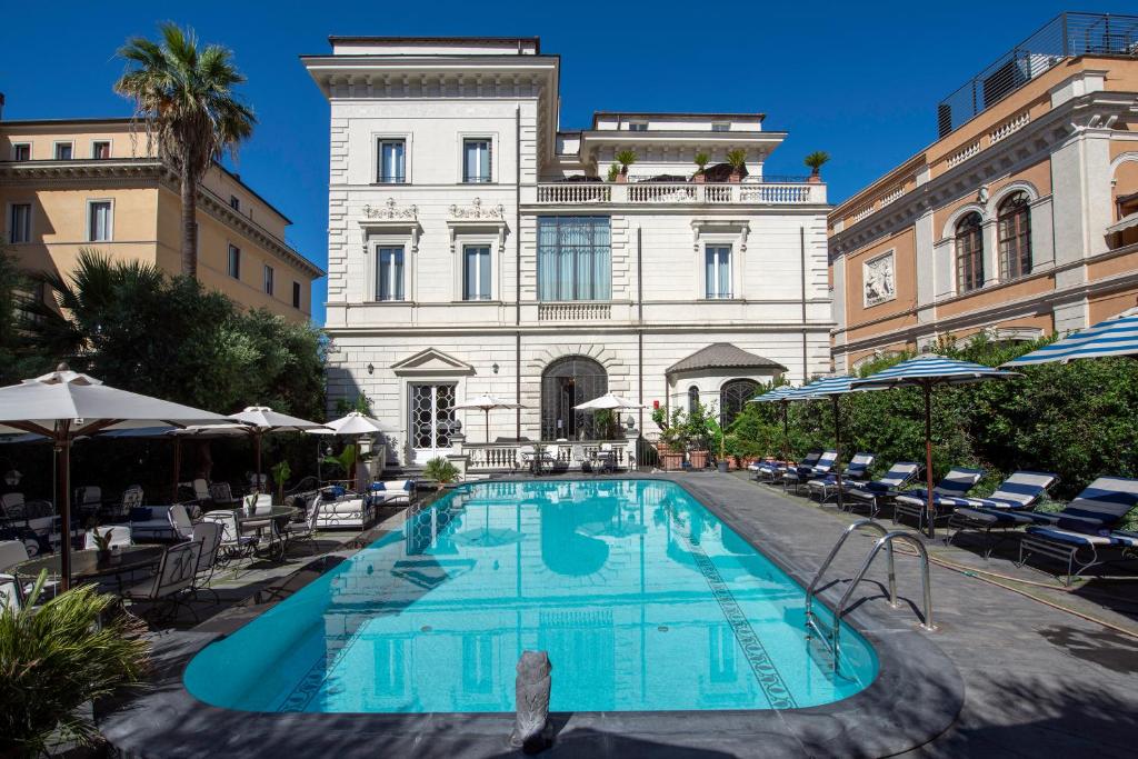 a swimming pool in front of a building at Palazzo Dama - Preferred Hotels & Resorts in Rome