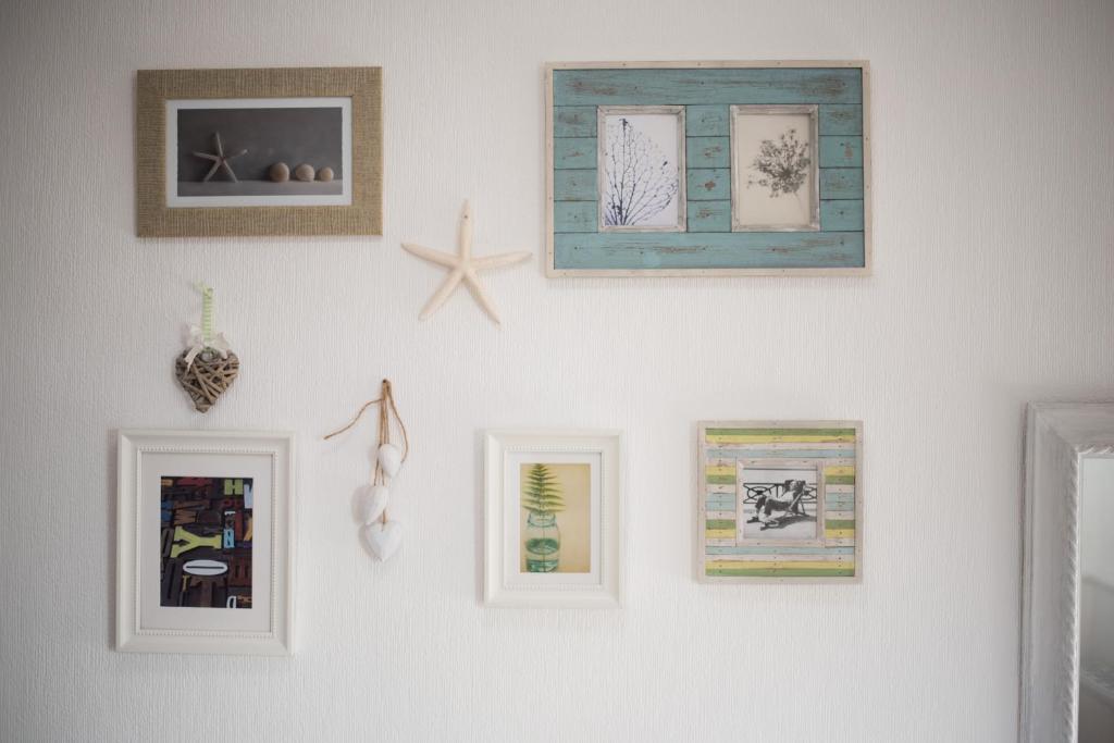 a white wall with pictures on it at Beachlands Hotel in Weston-super-Mare