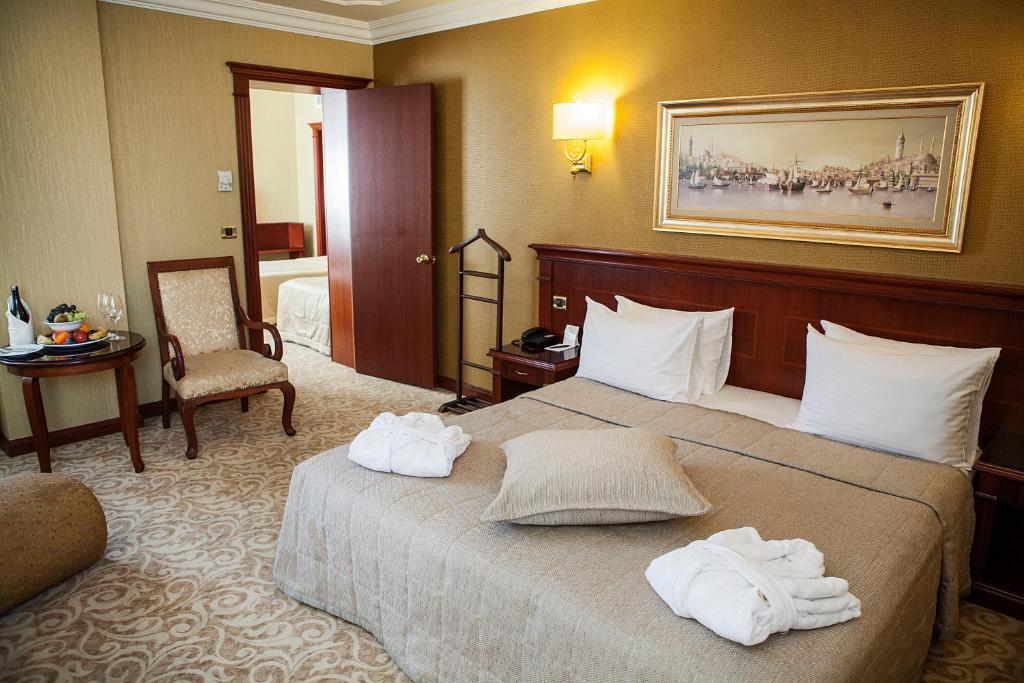 a hotel room with a bed with towels on it at Bilek Istanbul Hotel in Istanbul