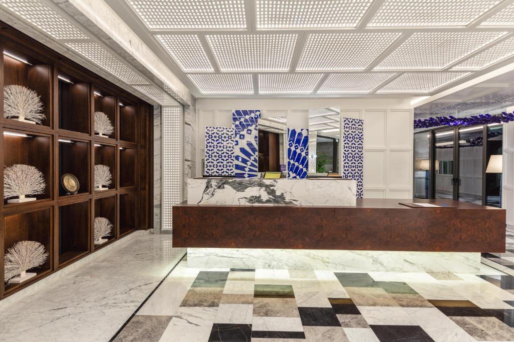 a lobby with a reception desk in a building at Kaya Palazzo Resort & Residences Le Chic Bodrum in Bodrum City