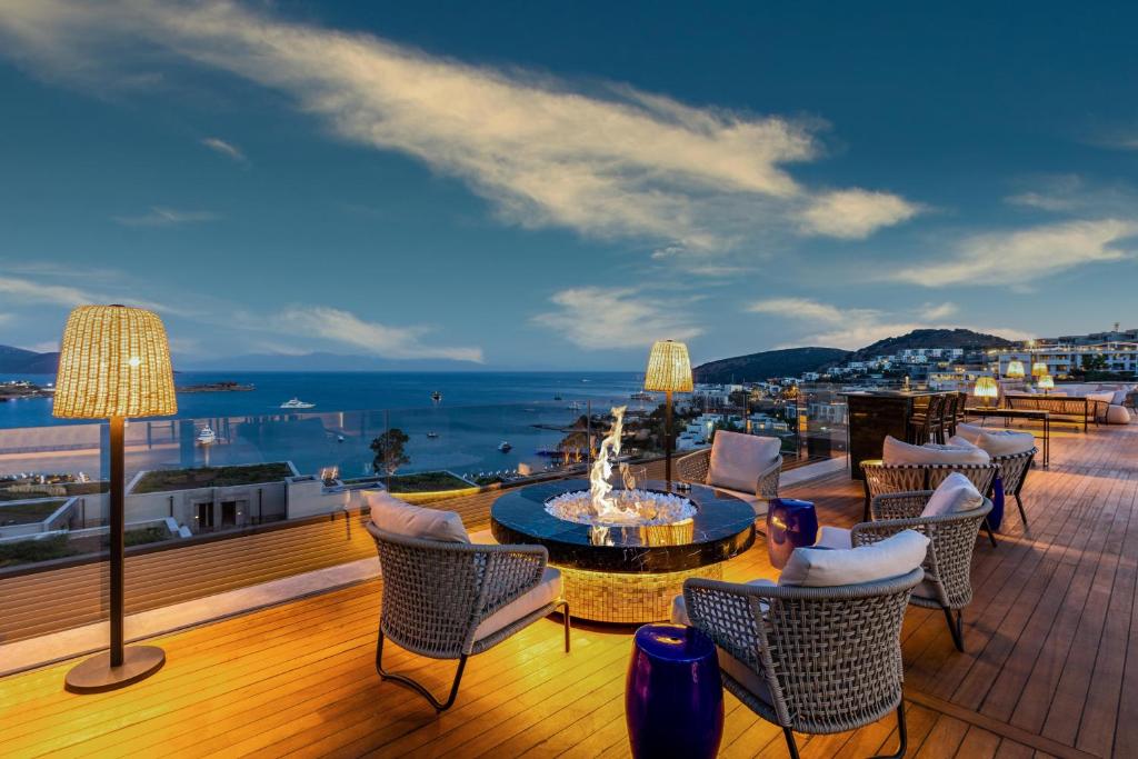a balcony with chairs and a fountain on a building at Kaya Palazzo Resort & Residences Le Chic Bodrum in Bodrum City