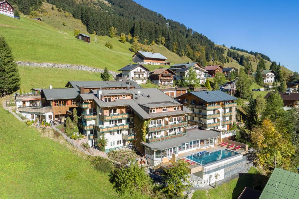 an aerial view of a large house on a hill at Der Kleinwalsertaler Rosenhof in Mittelberg