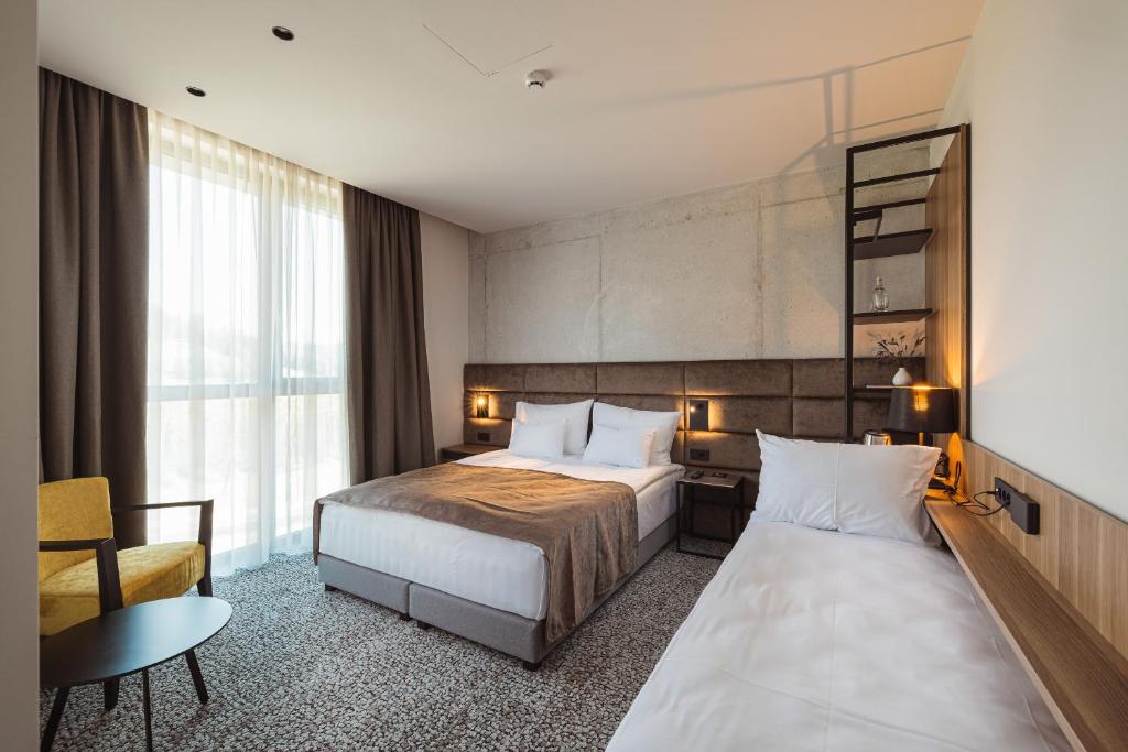 Postel nebo postele na pokoji v ubytování Hotel Grof