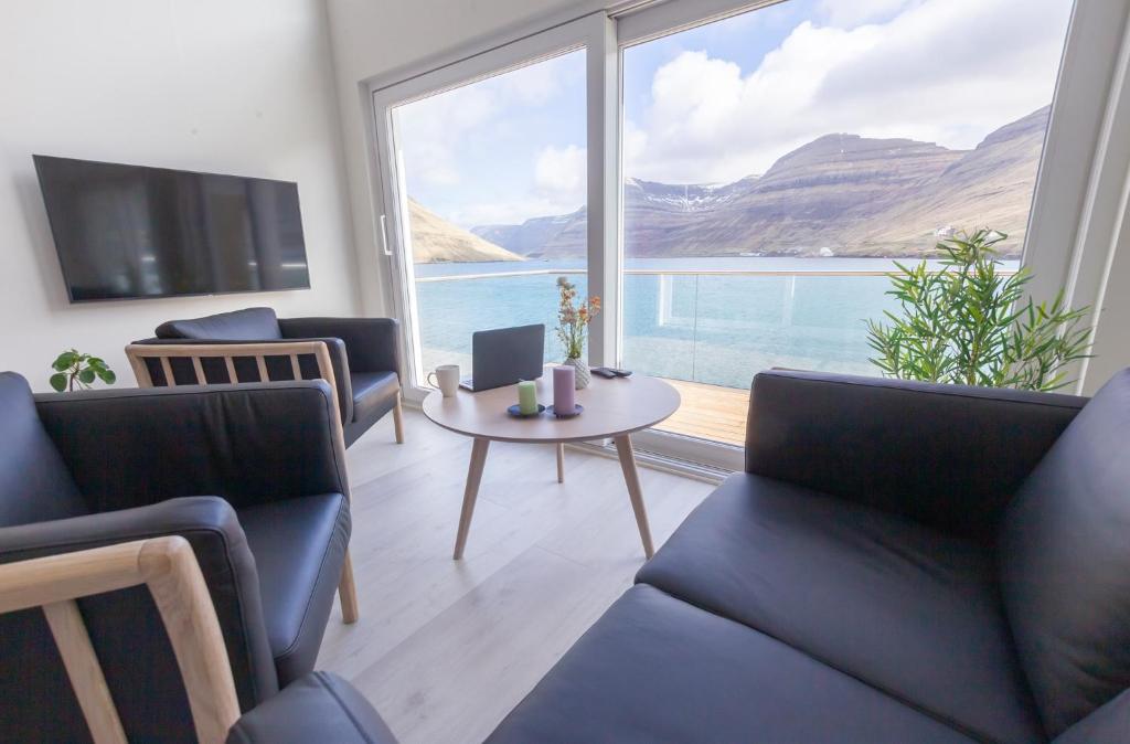 a living room with a view of the water at Panorama boathouse in Klaksvík