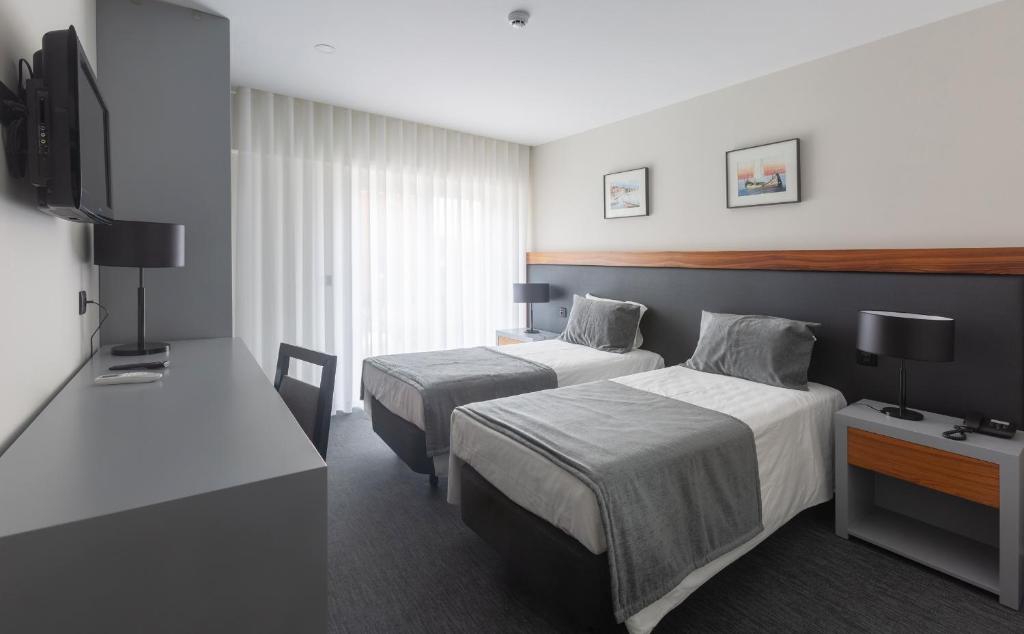 Postel nebo postele na pokoji v ubytování Hotel Afonso V & SPA