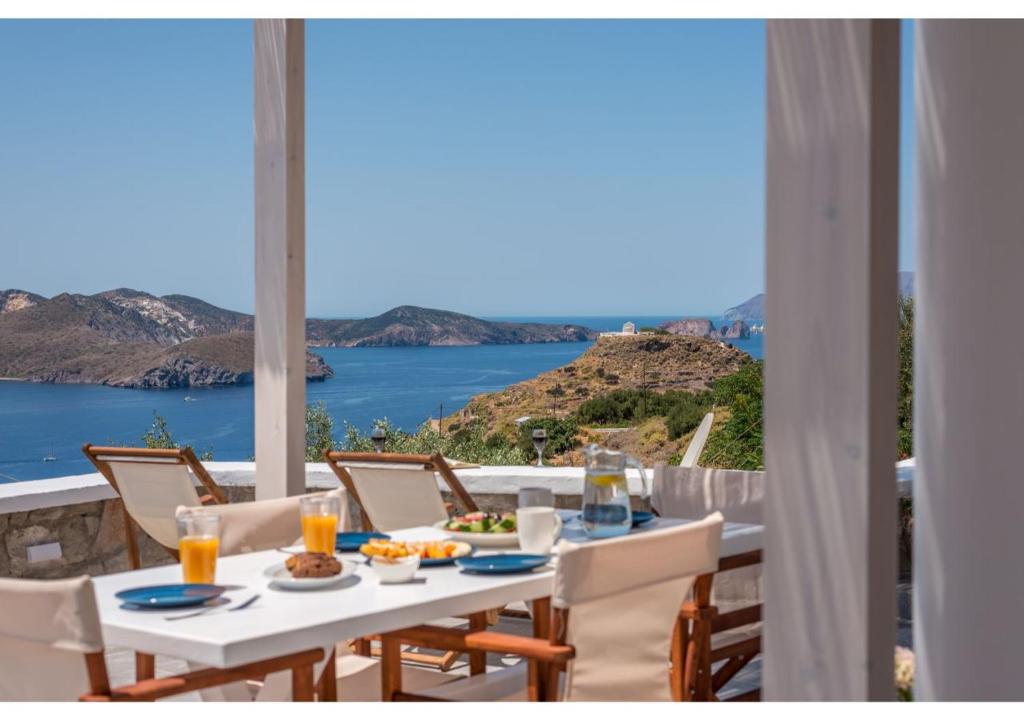 a table with food and a view of the ocean at Pasithea Deluxe in Tripiti