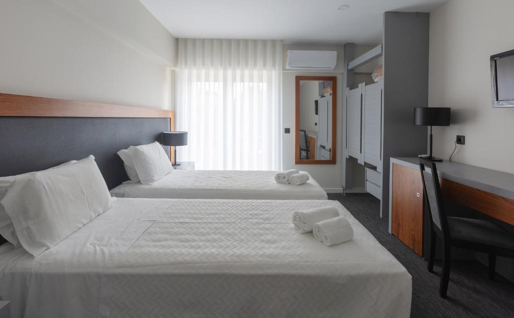 Postel nebo postele na pokoji v ubytování Hotel Afonso V & SPA