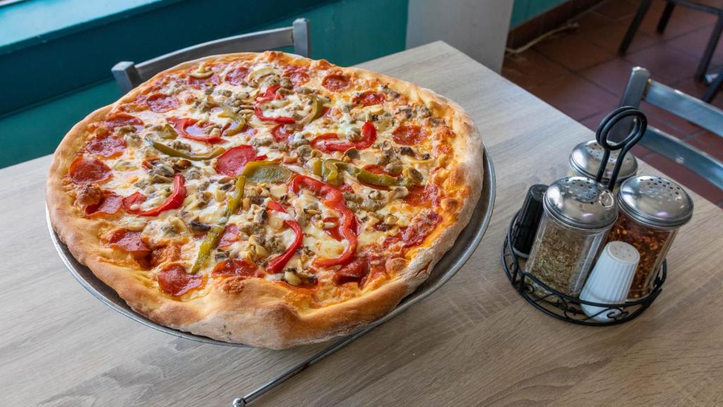 a pizza sitting on top of a table at Rideau Oceanfront Motel in Ocean City