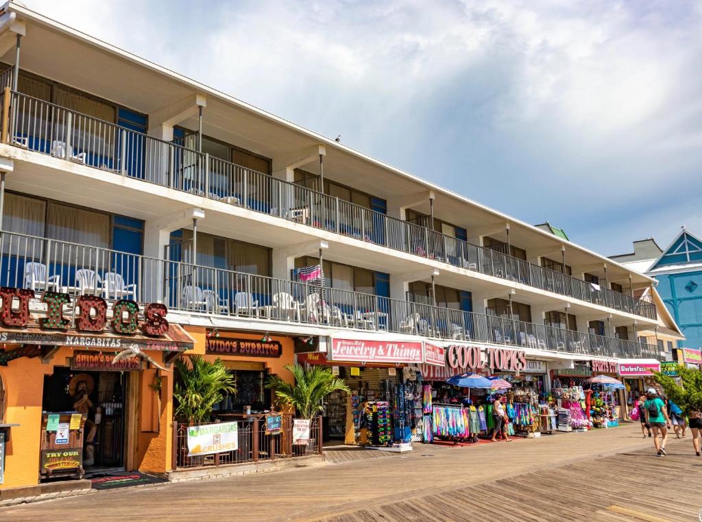 a building with balconies on a street with shops at Rideau Oceanfront Motel in Ocean City