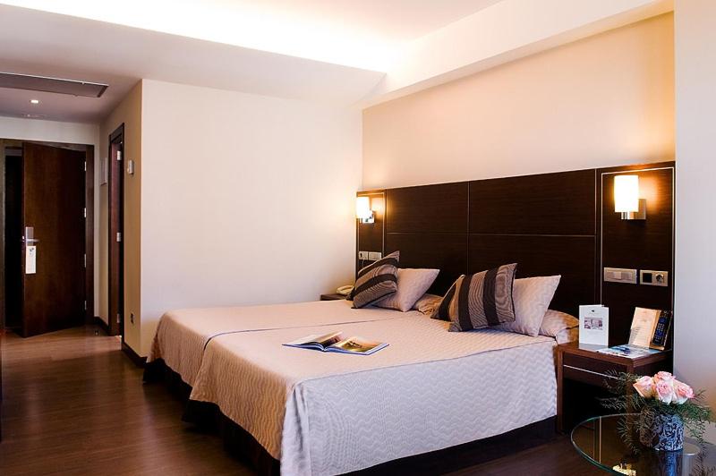 a bedroom with a large bed in a room at Hotel Coia de Vigo in Vigo