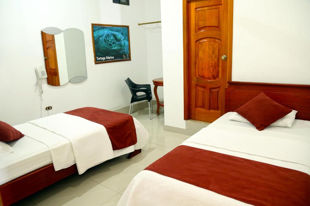 Postel nebo postele na pokoji v ubytování Hostal Sir Francis Drake