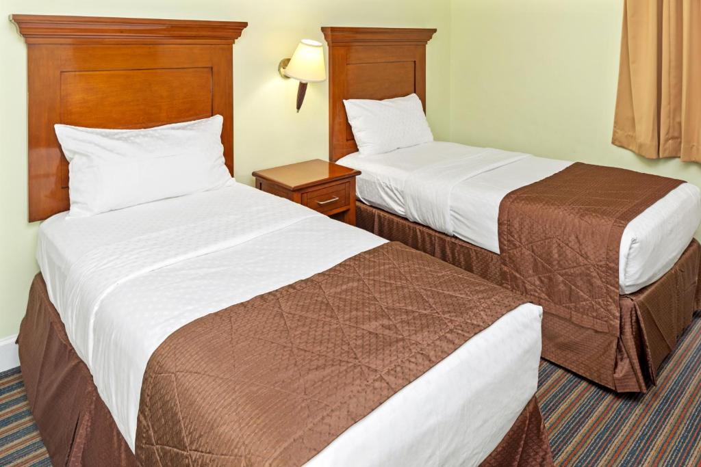 Postel nebo postele na pokoji v ubytování Hilton Vacation Club Grand Beach Orlando