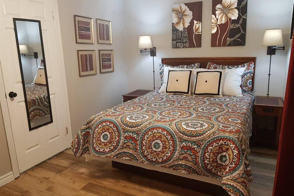 a bedroom with a bed with a comforter and pillows at Sarnia's Hidden Gem - 3 BR/2 BA by College/Hwy/Arena in Sarnia