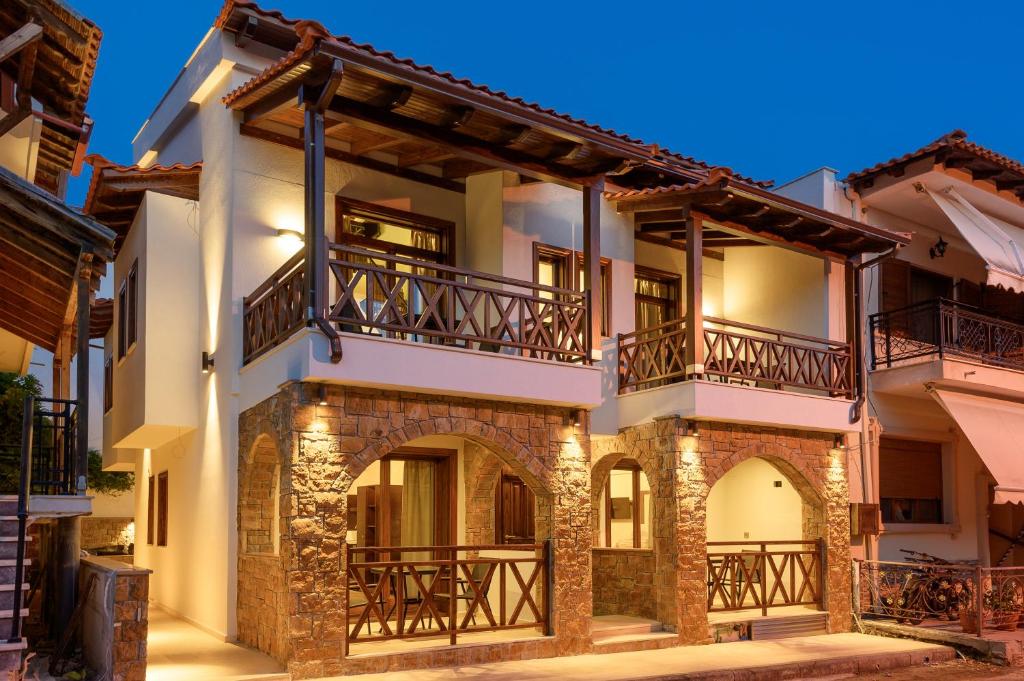 a large house with balconies on a street at Arxontariki Suites in Ouranoupoli