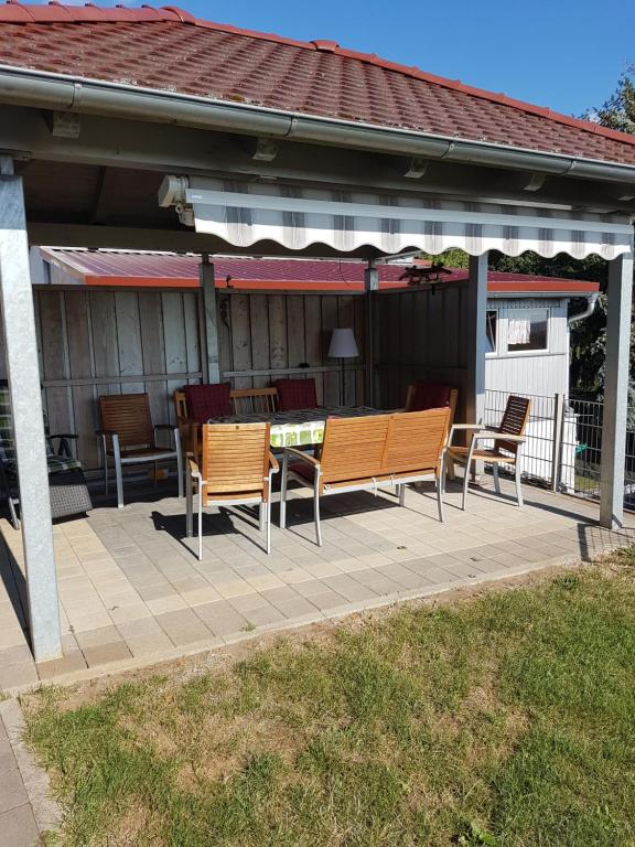 a patio with chairs and a table and a pavilion at Ferienwohnung Odorfer in Pleinfeld