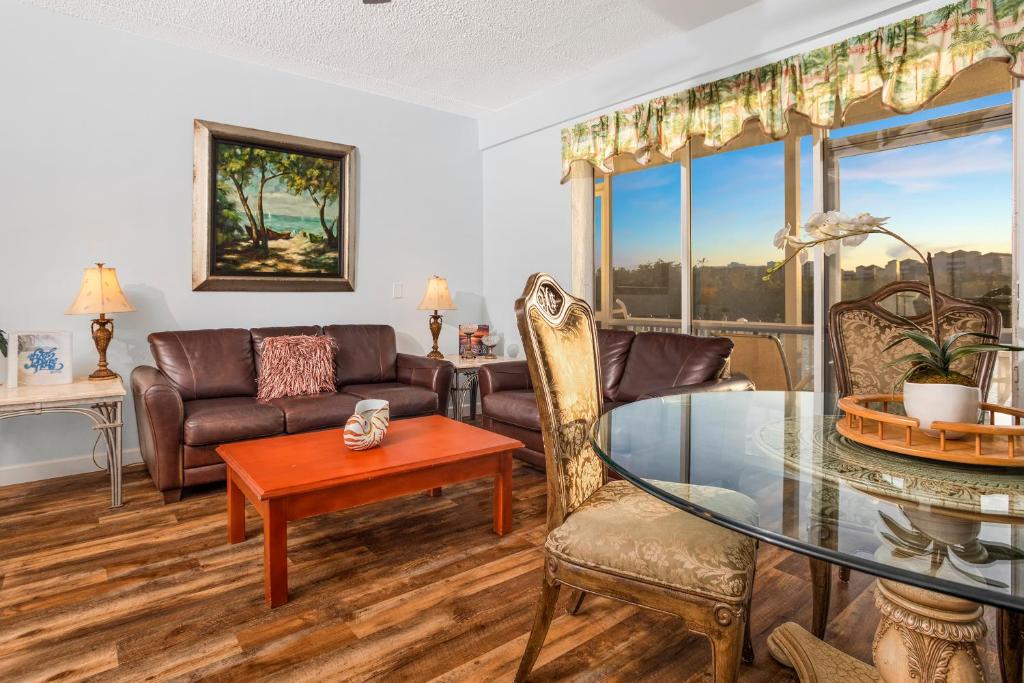 a living room with a glass table and chairs at The BoatHouse in Marco Island