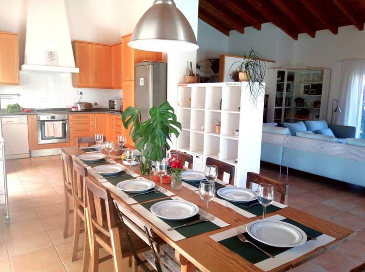a kitchen with a table with chairs and a dining room at Endless Summer Surf House in Aljezur