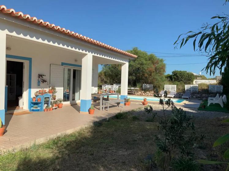 a patio of a house with a table and chairs at Endless Summer Surf House in Aljezur