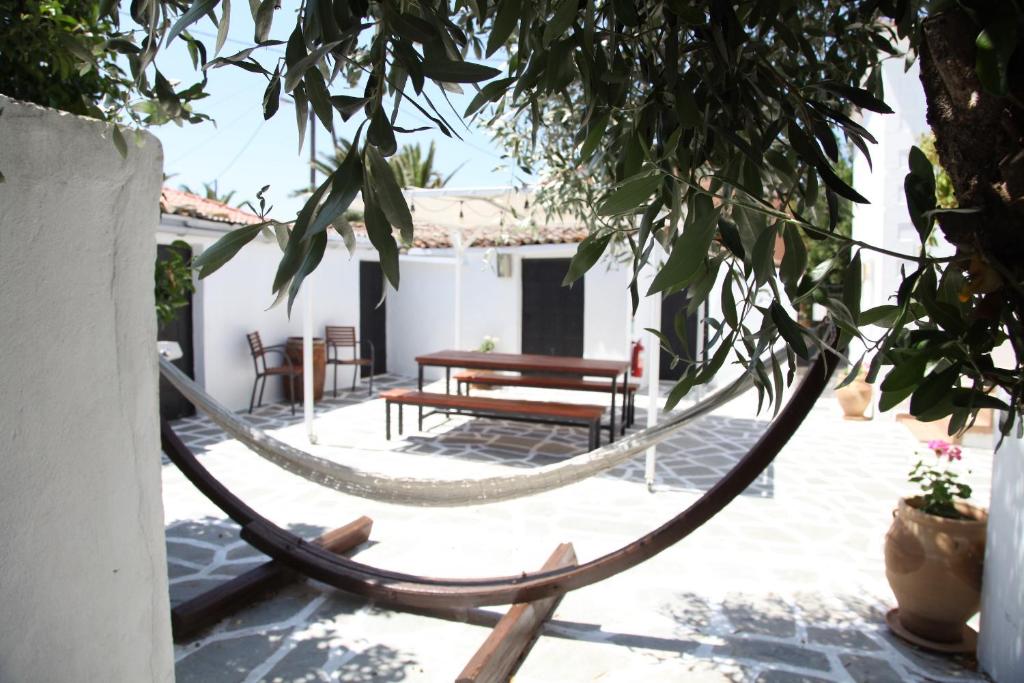 a hammock tied to a tree in a courtyard at Keros Apartments in Kalliópi