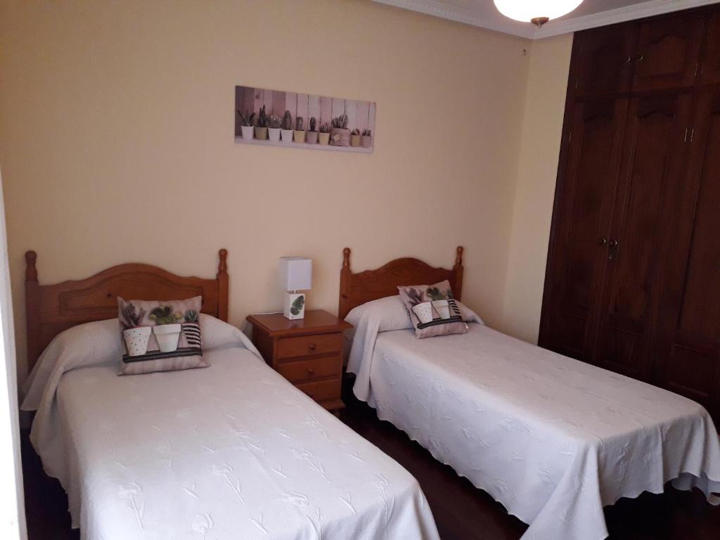 A bed or beds in a room at Apartamentos Los Frutales