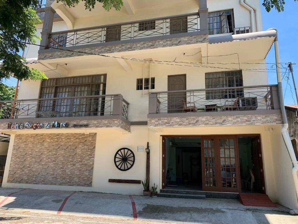 a large white building with balconies on it at Beinte Singko de Marso Apartments in Candon