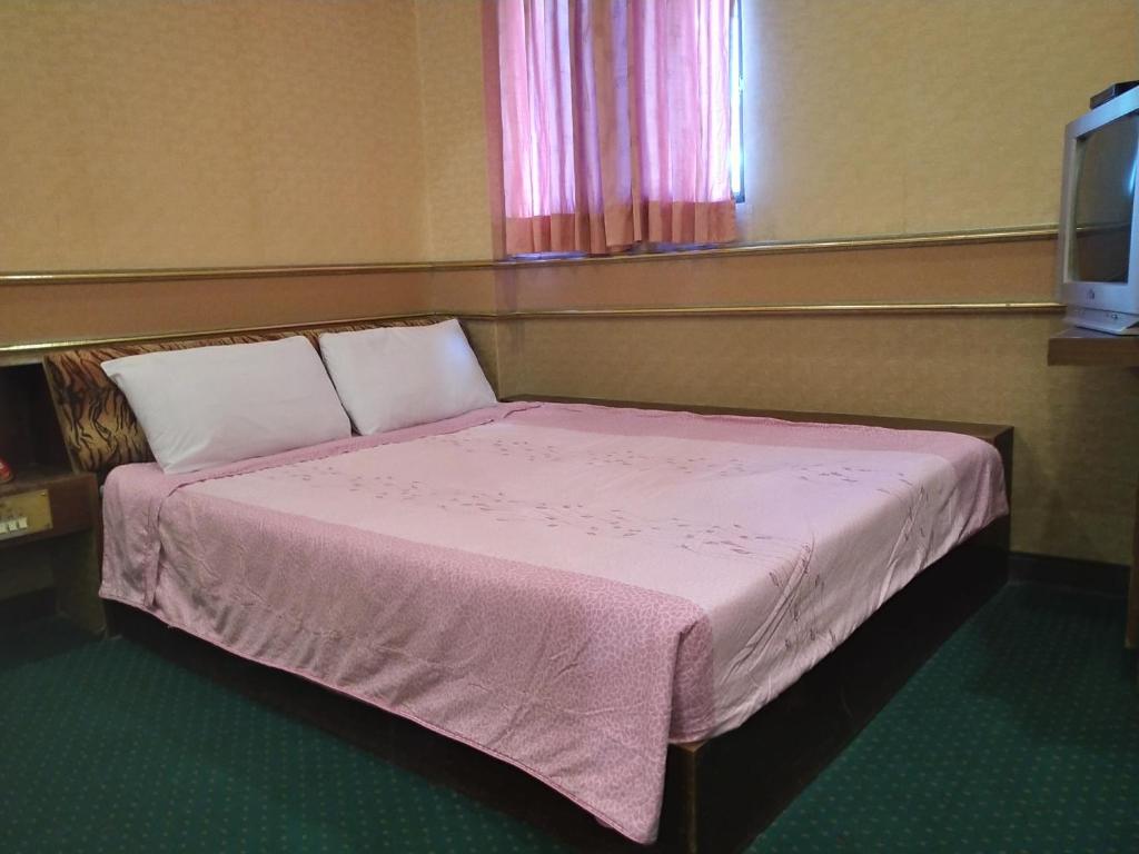 Postel nebo postele na pokoji v ubytování The LEY HOTEL 寶麗頌旅館
