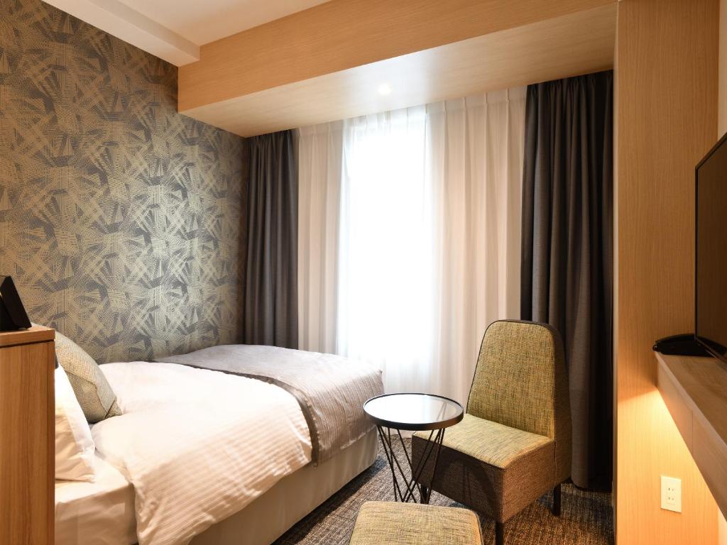 Postel nebo postele na pokoji v ubytování Hotel Keihan Sendai