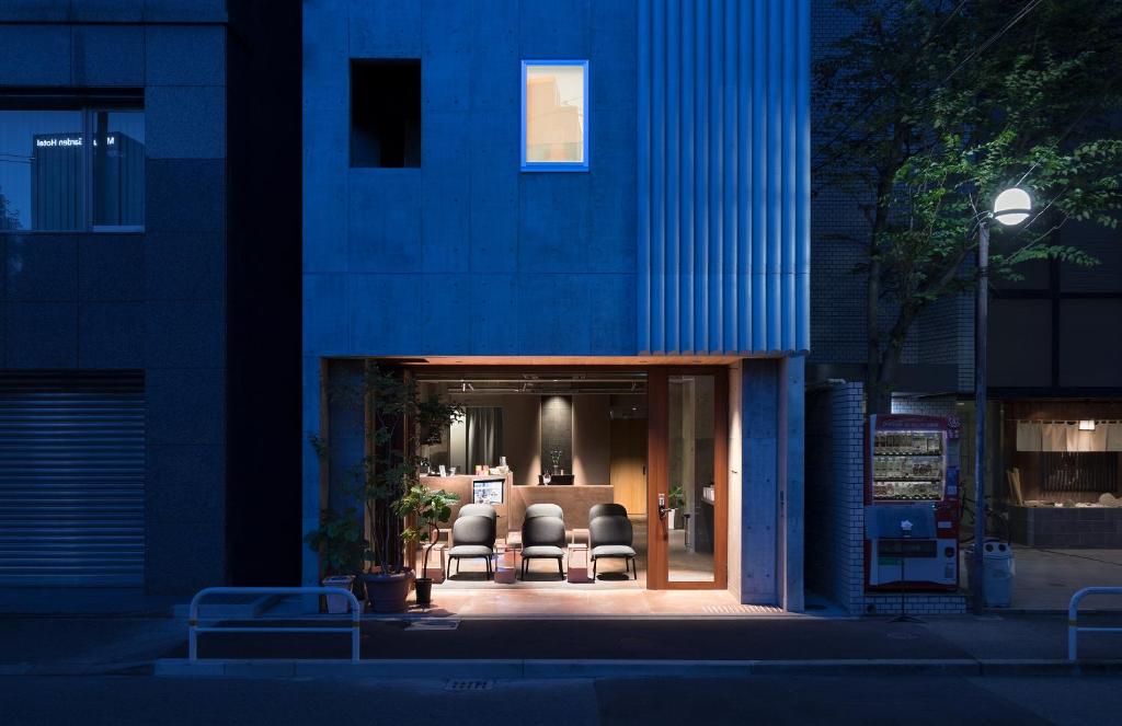 a blue building with chairs in front of it at BUNSHODO HOTEL in Fukuoka