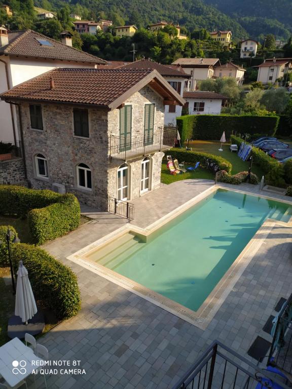 a villa with a swimming pool in front of a house at BELLA VITA! in Bellagio