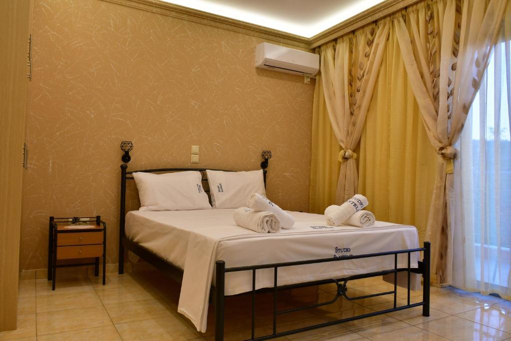 a bedroom with a bed with towels on it at Studios Pantelis Corfu in Ipsos