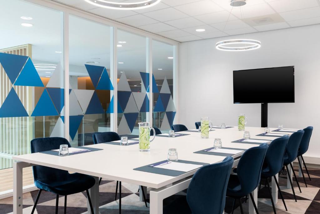a conference room with a long table and chairs at Holiday Inn Express Amsterdam - North Riverside by IHG in Amsterdam