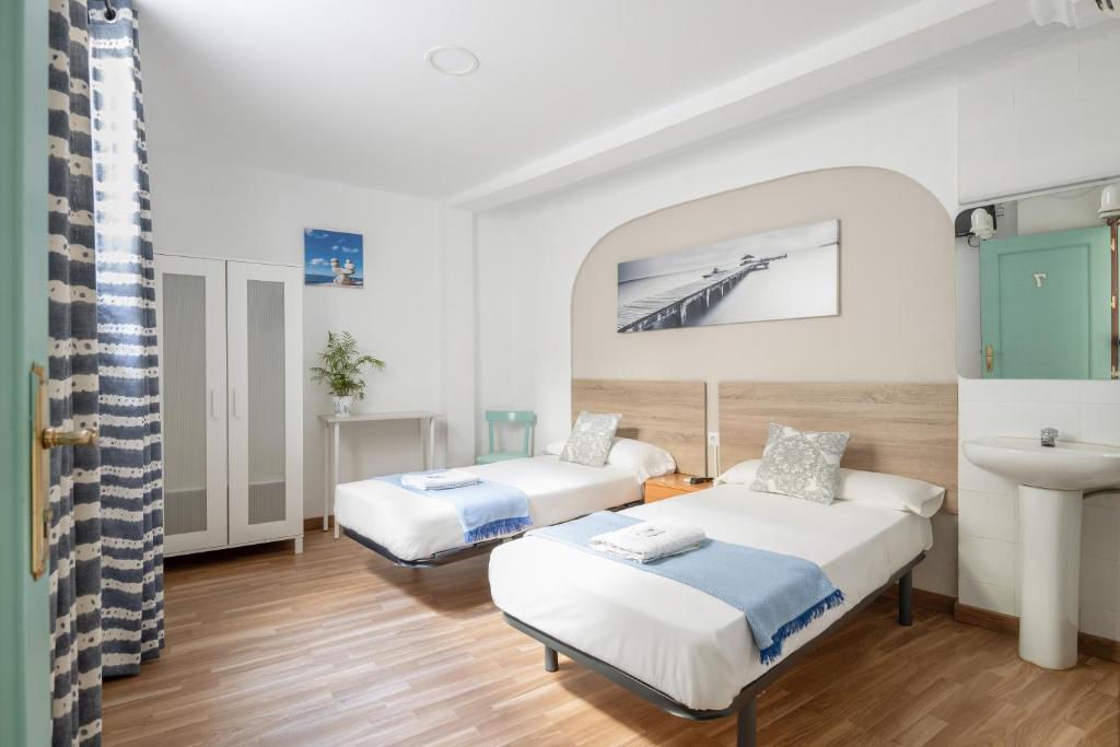Postel nebo postele na pokoji v ubytování Pensión Zacatin