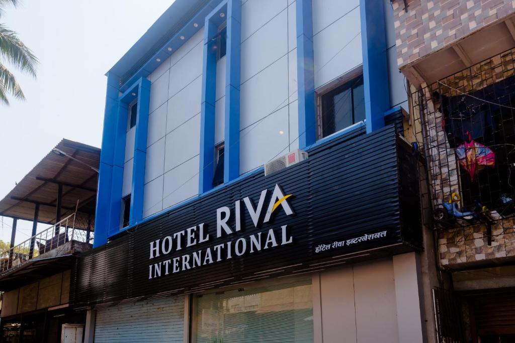 a hotelryan international sign on the side of a building at Hotel Riva International- Goregaon West Mumbai in Mumbai