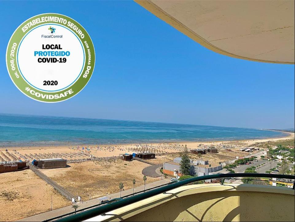 vistas a una playa con el océano en el fondo en Apartamentos Guadiana, en Monte Gordo