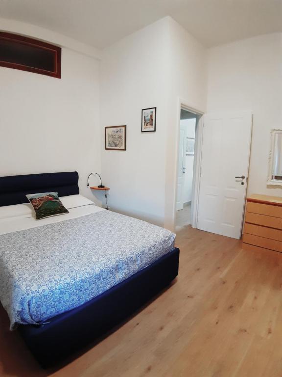 a bedroom with a bed and a wooden floor at HOUSE Riccardo Cinque terre 30 minuti in Sestri Levante