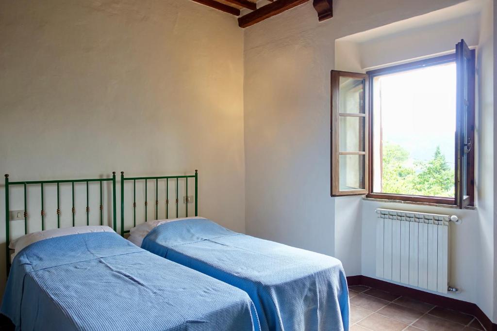 Łóżko lub łóżka w pokoju w obiekcie Casa alla Vecchia Posta di Bagno Vignoni