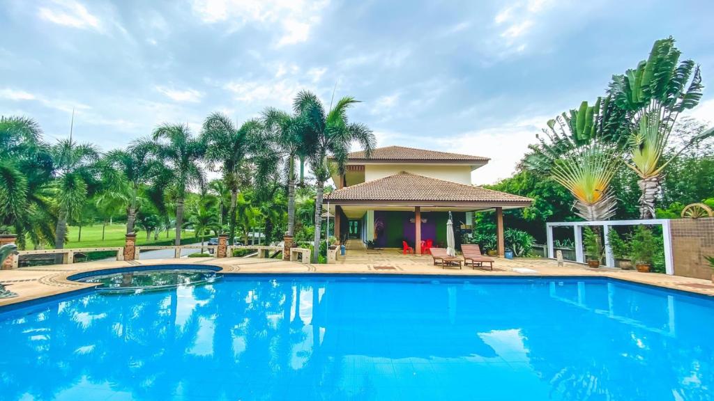 a large swimming pool in front of a house at Muak Lek Forest Resort in Muaklek