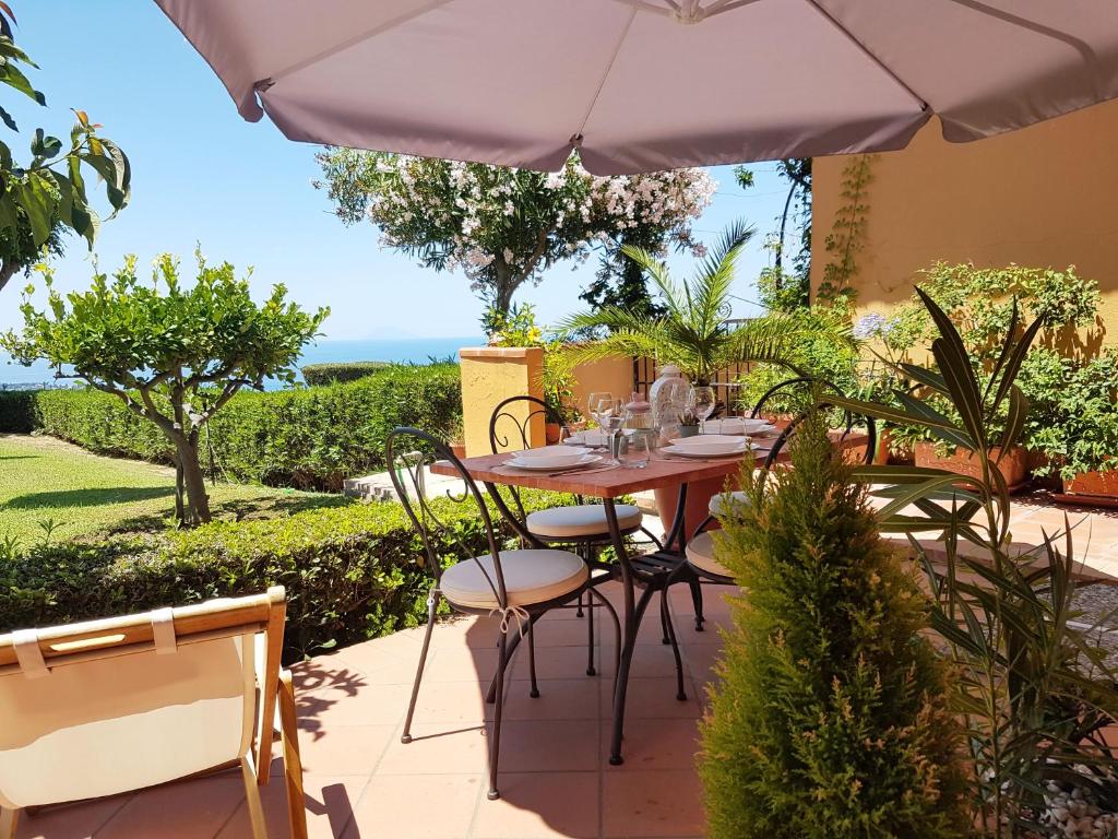 a table and chairs under an umbrella on a patio at Il Settimo Cielo in Parghelia