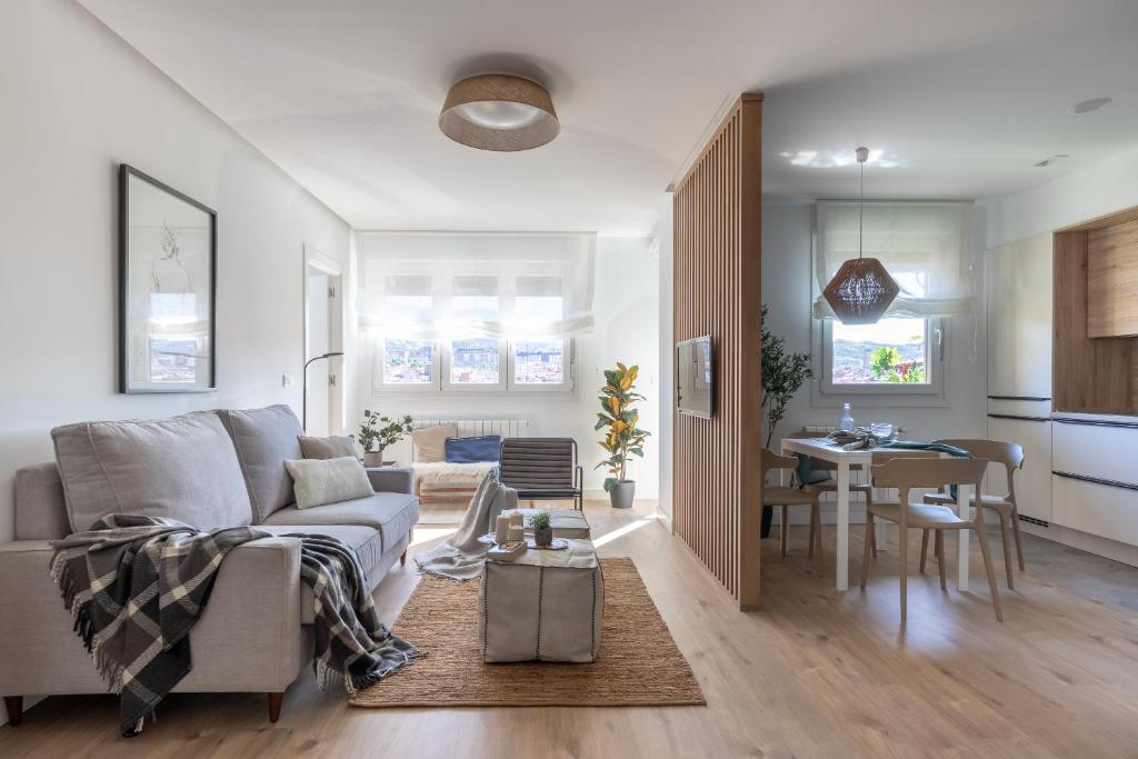 a living room with a couch and a table at Bilbao Sensations.OLD TOWN exclusive views&parking in Bilbao