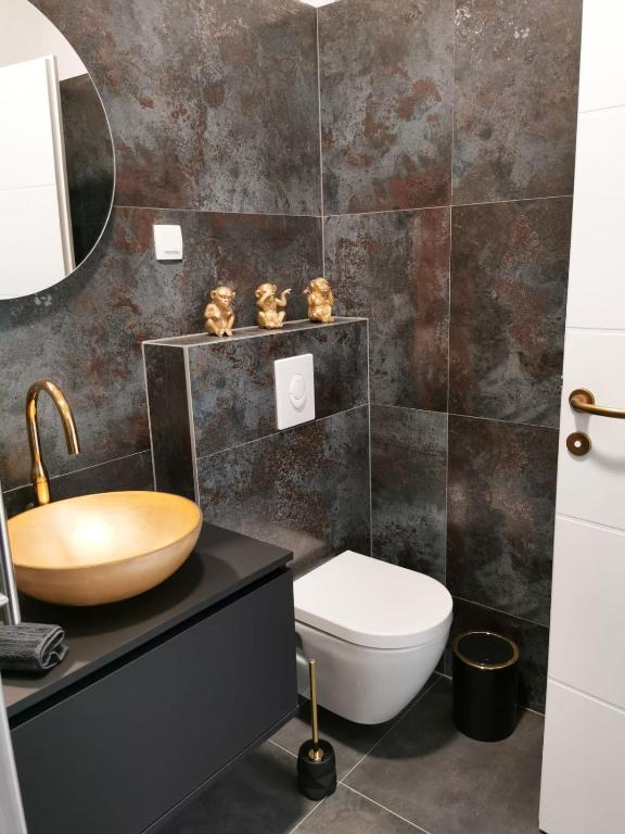 a bathroom with a sink and a toilet at Litore in Pula