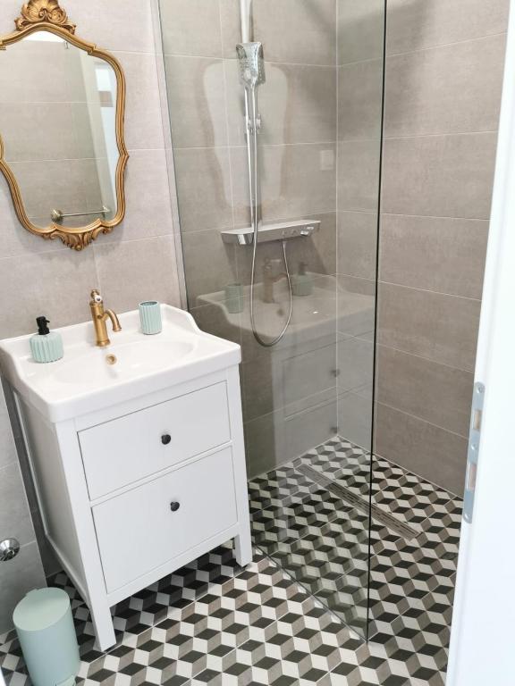 a bathroom with a sink and a shower at Litore in Pula