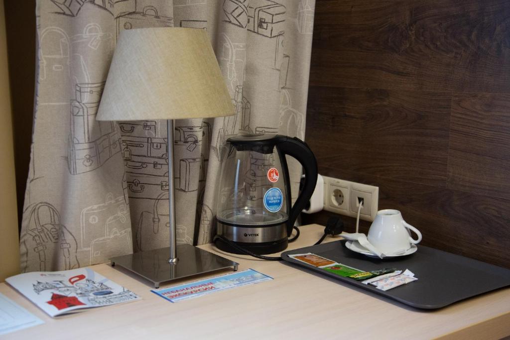 a coffee maker and a lamp on a desk at Business Hotel Diplomat in Nizhny Novgorod