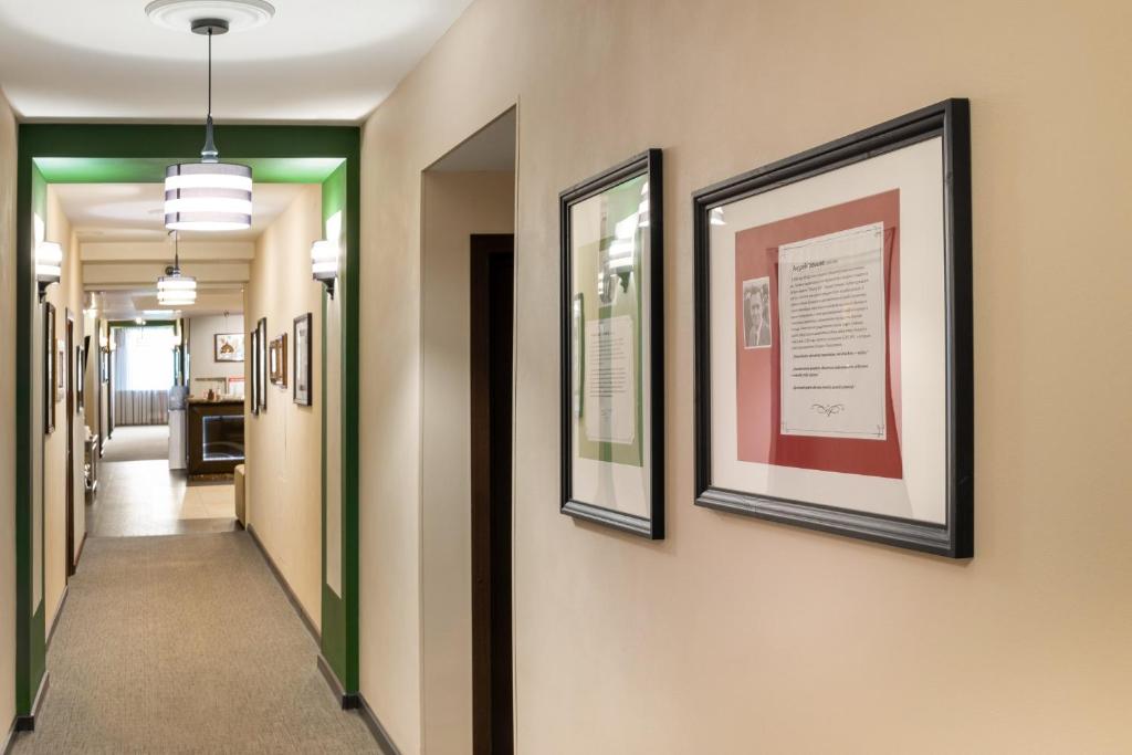 a hallway in a hospital with pictures on the walls at Business Hotel Diplomat in Nizhny Novgorod
