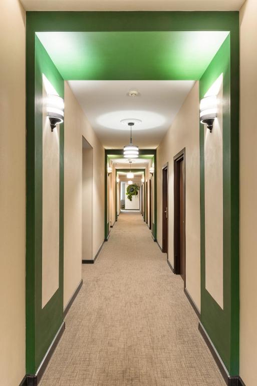 a corridor of an office building with a green ceiling at Business Hotel Diplomat in Nizhny Novgorod