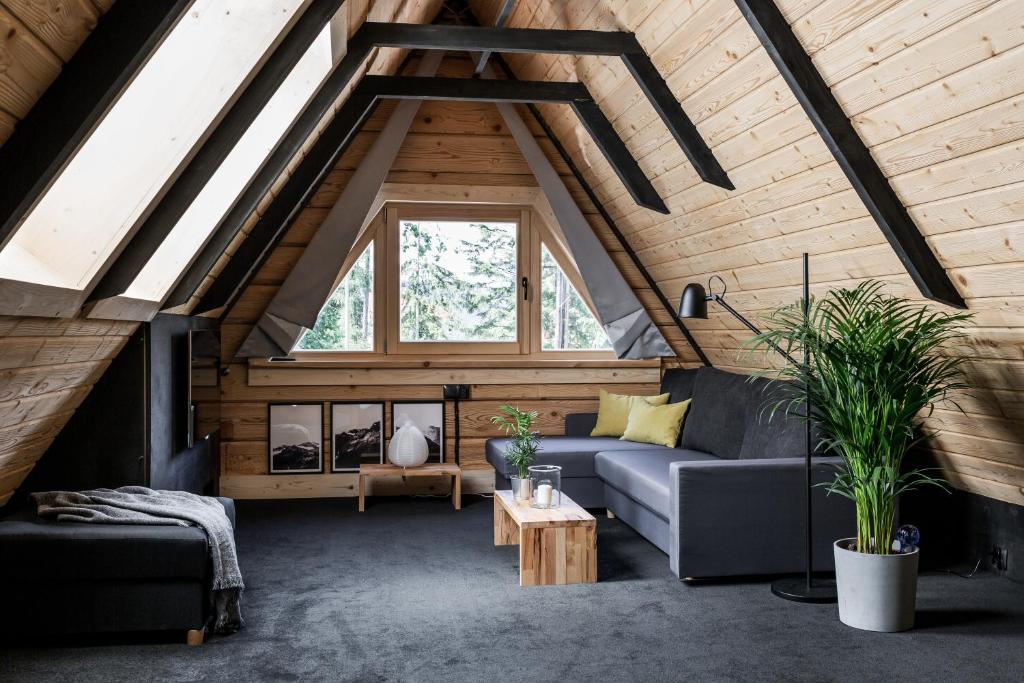 a living room with a couch and a window at Mount Apart Sport House in Zakopane