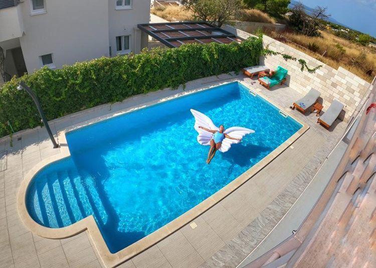 an overhead view of a swimming pool with a butterfly on it at Villa Amorena - Adults Only in Bol