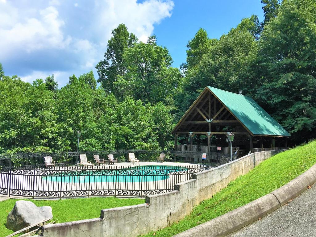 a wooden building with a green roof in a park at Honeymoon Sweet in Townsend