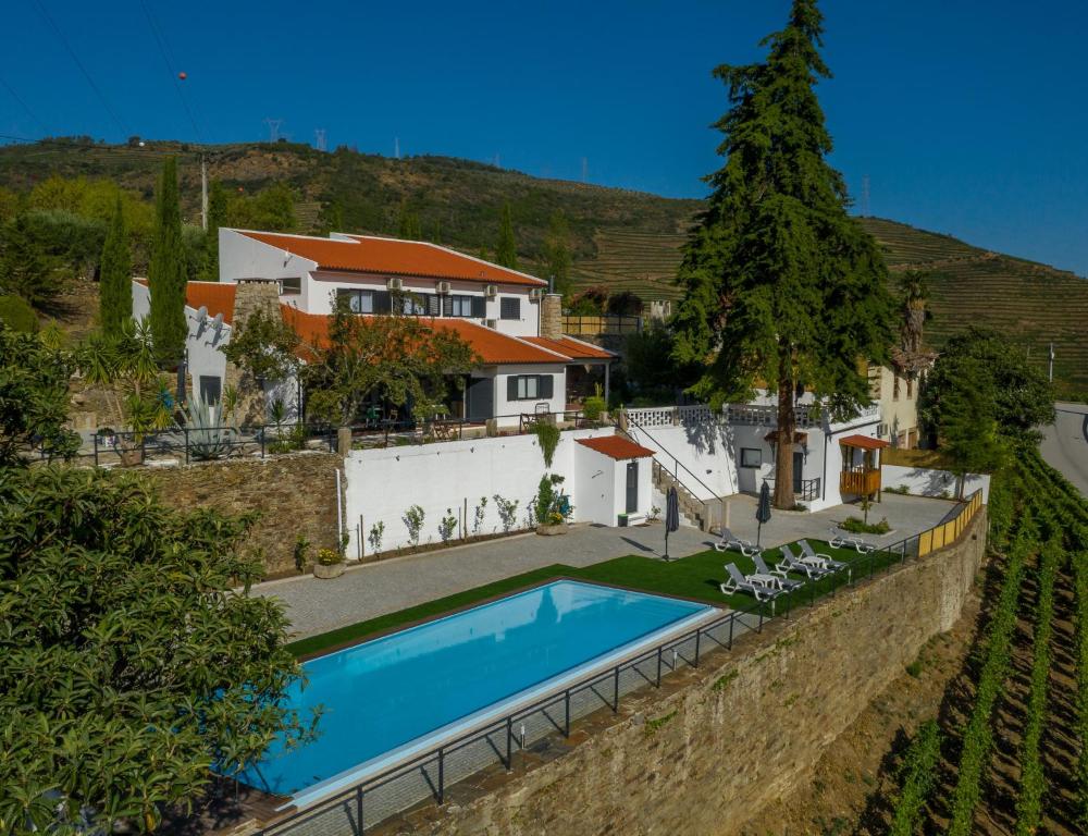 an aerial view of a house with a swimming pool at Quinta da Portela Douro in Armamar