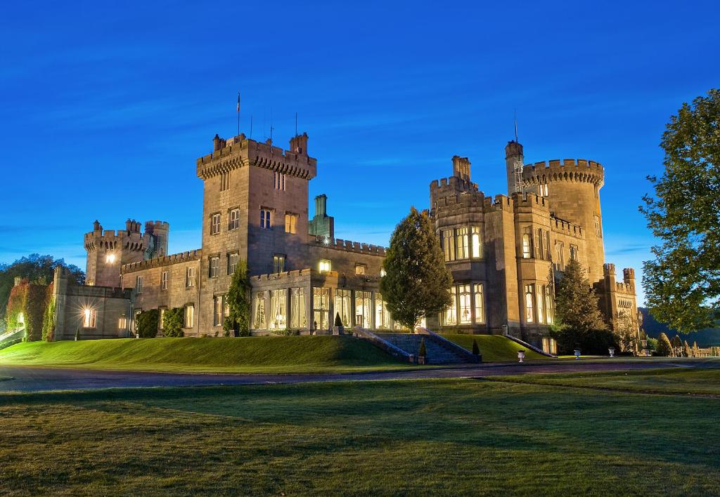 an old castle with a lawn in front of it at Dromoland Castle in Newmarket on Fergus