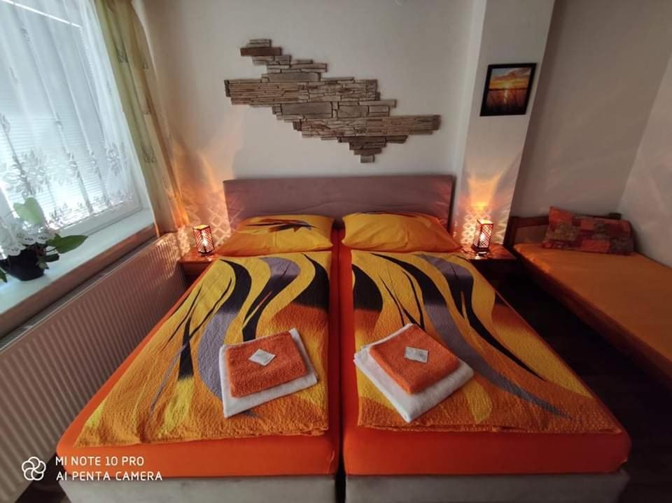 a bedroom with a bed with two boxes on it at Motel Podkova in Klobouky u Brna